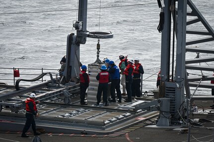 SECNAV Carlos Del Toro visits USNS Washington Chambers (T-AKE 11) during a demonstration of VLS reloading at-sea with USS Chosin (CG-65).