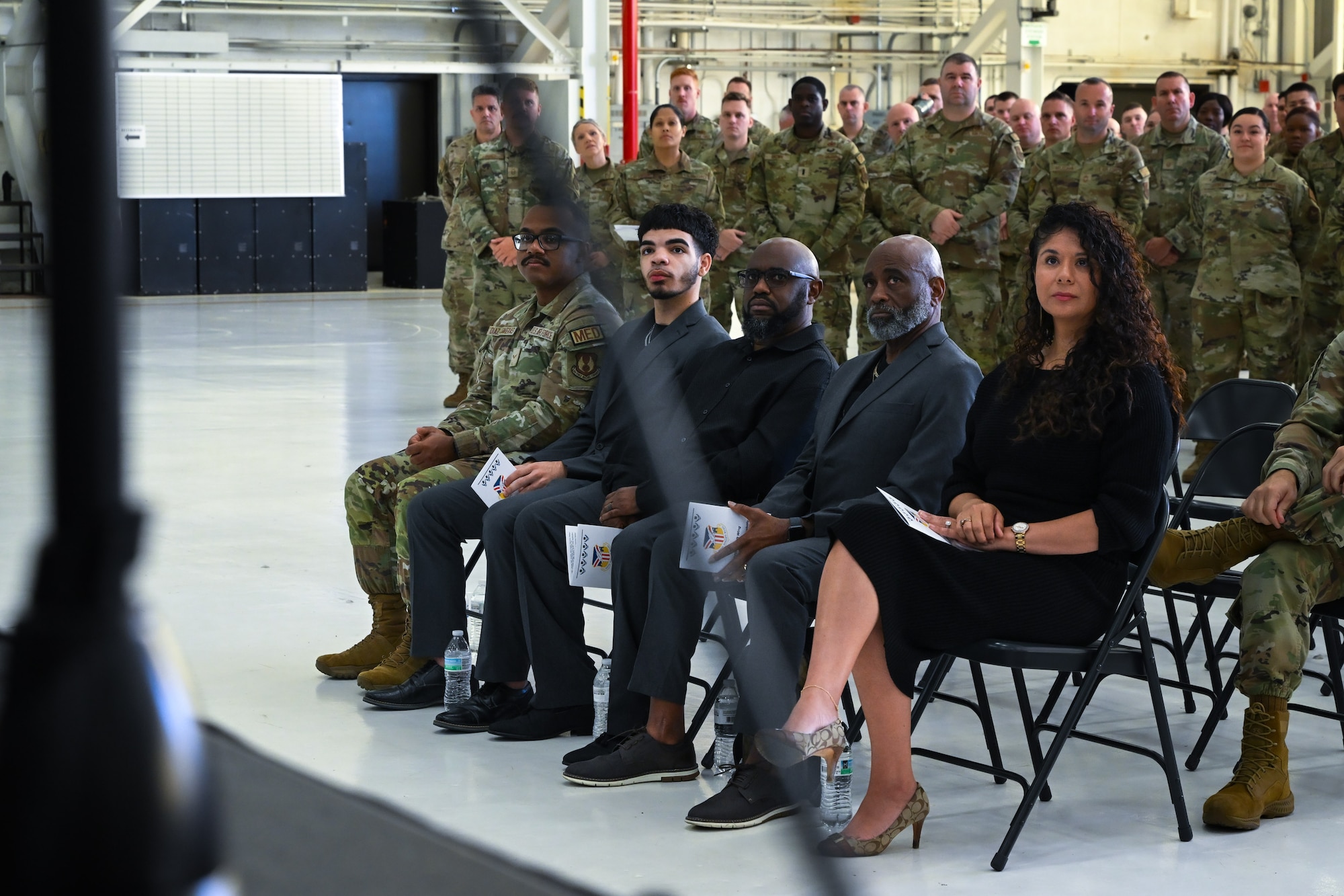 Family members of Chief Master Sgt. Howard Dixon, 910th Airlift Wing command chief, listen to remarks given by Dixon during his change of responsibility ceremony at Youngstown Air Reserve Station, Ohio, Oct. 5, 2024.