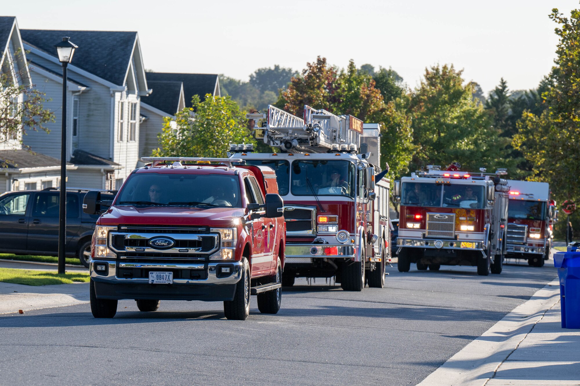 Firetrucks and first responder vehicles belonging to the 436th Civil Engineer Squadron move through base housing during the 2024 Fire Prevention Week Parade at Dover Air Force Base, Delaware, Oct. 11, 2024. During Fire Prevention Week, the 436th CES firefighters provided the Dover community with lifesaving education in an effort to decrease fire safety hazards. (U.S. Air Force photo by Mauricio Campino)
