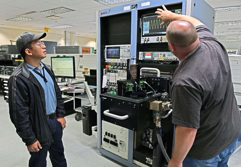 Two men assessing a Versatile Diagnostic Automated Test Station