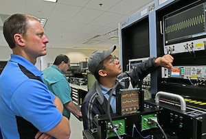 Two men assessing a Versatile Diagnostic Automated Test Station