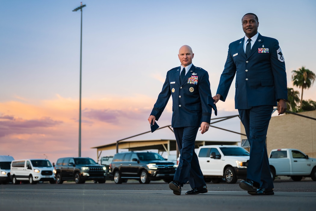 U.S. Air Force Brig. Gen. David Berkland (left), 56th Fighter Wing commander, and Chief Master Sgt. Quentin Davis (right), 56th Medical Group senior enlisted leader, walk onto the flightline to greet Singapore Armed Forces Vice Adm. Aaron Beng, Chief of Defense Force.