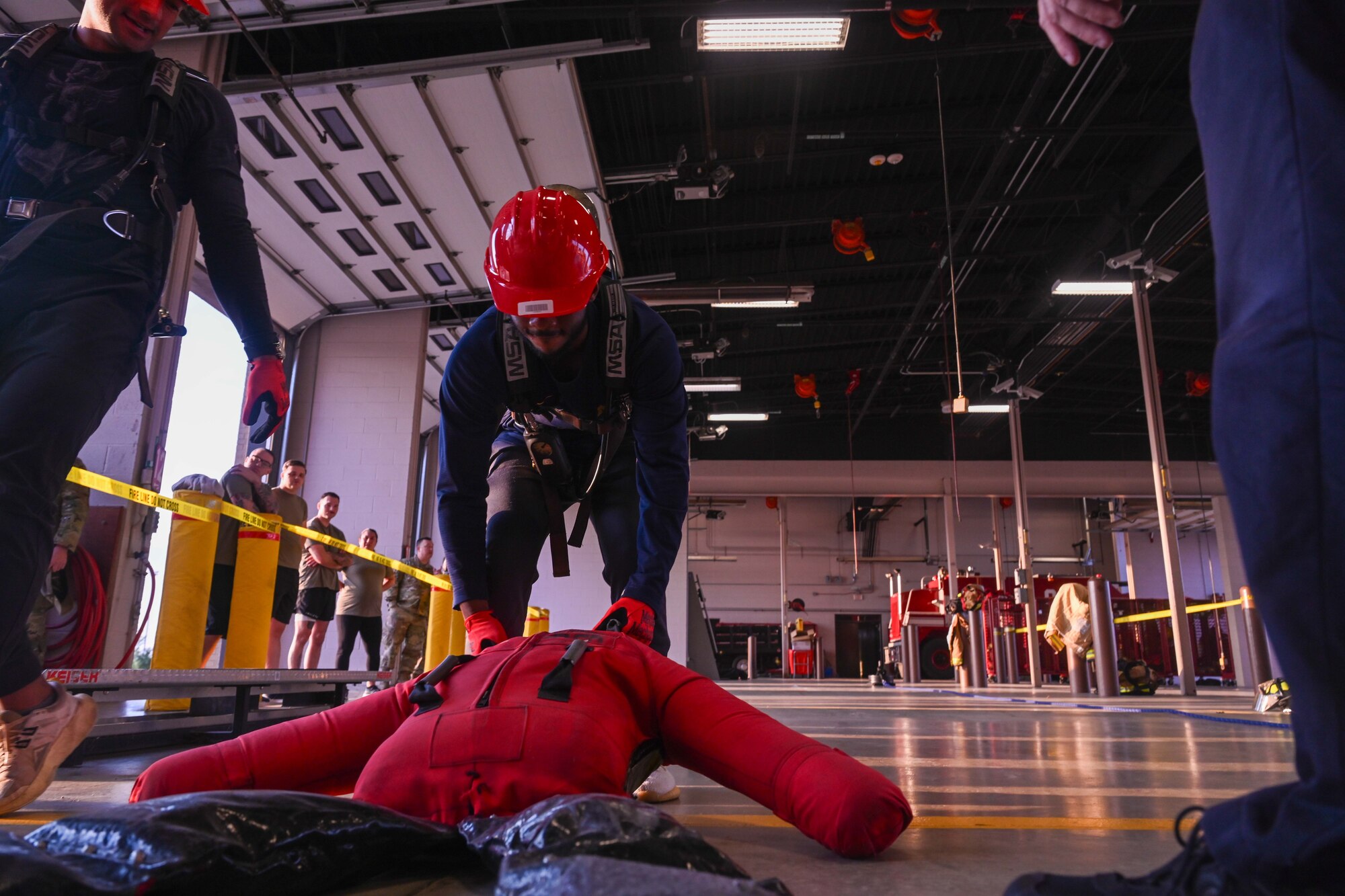 An Airman from the 722nd Maintenance Squadron drags a dummy during the annual 22nd Civil Engineer Squadron Fire Muster Oct. 10, 2024, at McConnell Air Force Base, Kansas. The Fire Muster consisted of five teams competing for the fastest time to complete various tasks such as unrolling a large fire hose, dragging a dummy and spraying a fire hose at a target. (U.S Air Force photo by Senior Airman William Lunn)
