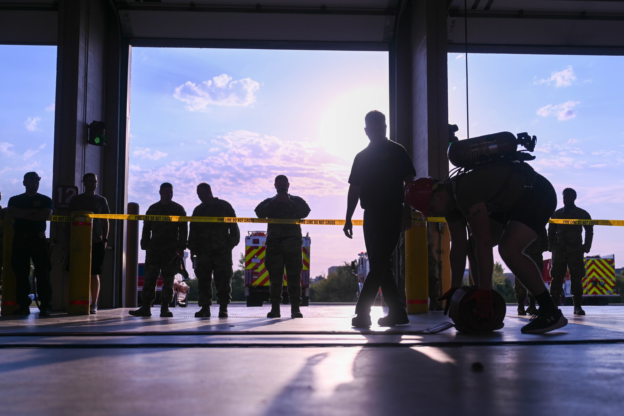 An Airman from the 22nd Contracting Squadron rolls a fire hose during the annual 22nd Civil Engineer Squadron Fire Muster Oct. 10, 2024, at McConnell Air Force Base, Kansas. The Fire Muster consisted of five teams competing for the fastest time to complete various tasks such as unrolling a large fire hose, dragging a dummy and spraying a fire hose at a target. (U.S Air Force photo by Senior Airman William Lunn)