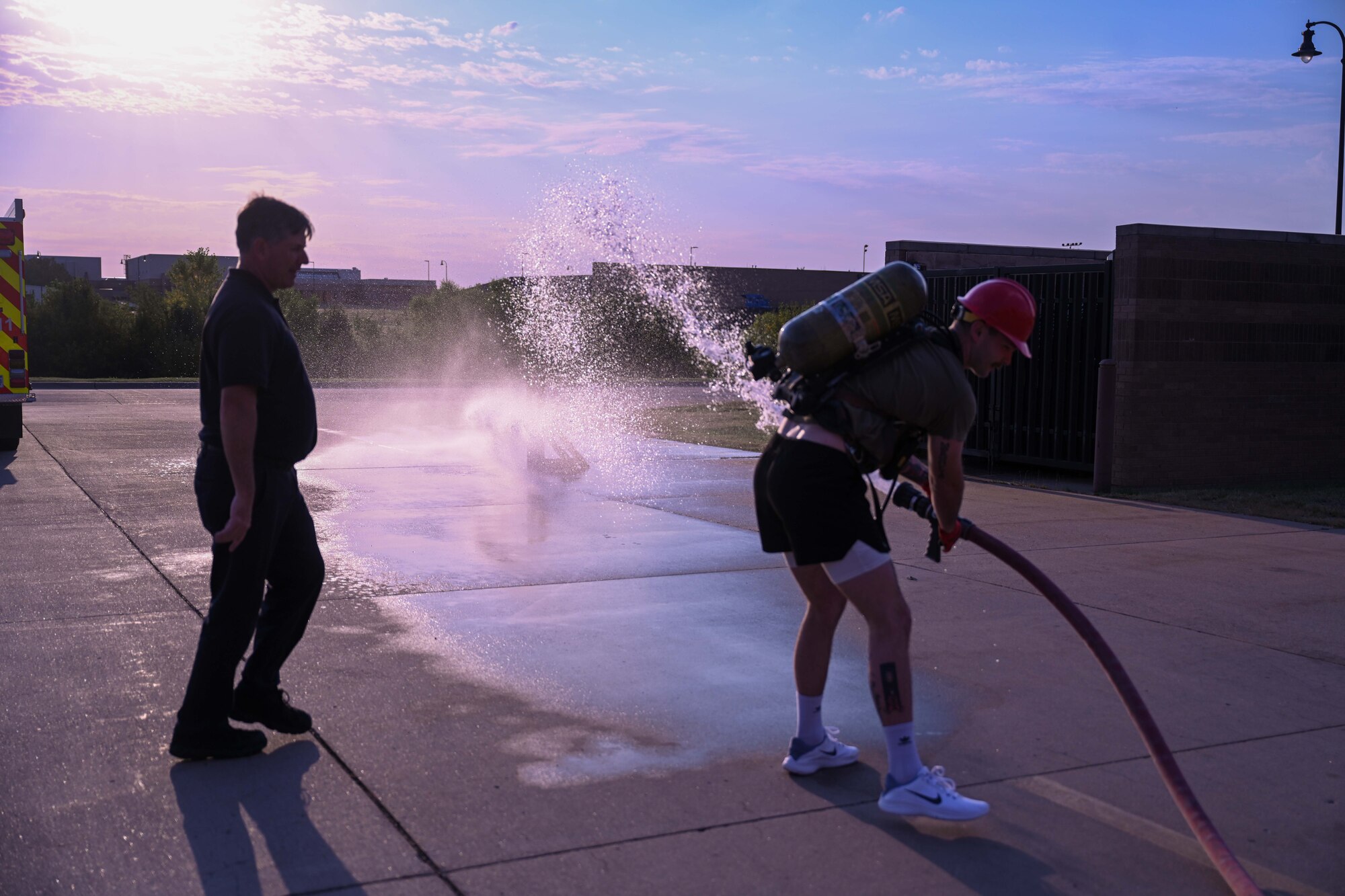 An Airman from the 22nd Contracting Squadron uses a fire hose during the annual 22nd Civil Engineer Squadron Fire Muster Oct. 10, 2024, at McConnell Air Force Base, Kansas. The Fire Muster consisted of five teams competing for the fastest time to complete various tasks such as unrolling a large fire hose, dragging a dummy and spraying a fire hose at a target. (U.S Air Force photo by Senior Airman William Lunn)
