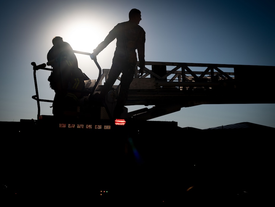 Team Dover Firemen from the 436th Civil Engineer Squadron Fire Department, demonstrate how to climb an aerial during an open house at Dover Air Force Base, Delaware, Oct. 10, 2024. The open house took place during Fire Prevention Week, a nationally observed week used to educate people on fire prevention. (U.S. Air Force Photo by Dieondiere Jefferies)