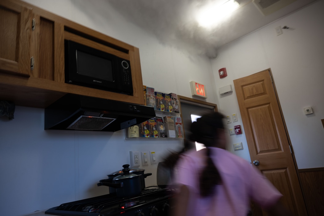 A young Team Dover member moves quickly during a simulated house fire during an open house at Dover Air Force Base, Delaware, Oct. 10, 2024. The open house took place during Fire Prevention Week, a nationally observed week used to educate people on fire prevention. (U.S. Air Force Photo by Dieondiere Jefferies)