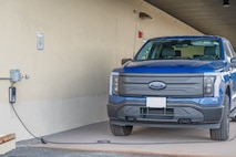 Photo of electric vehicle plugged in to outlet