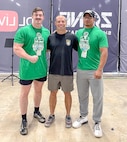 Three men stand side-by-side in front of branded background display.