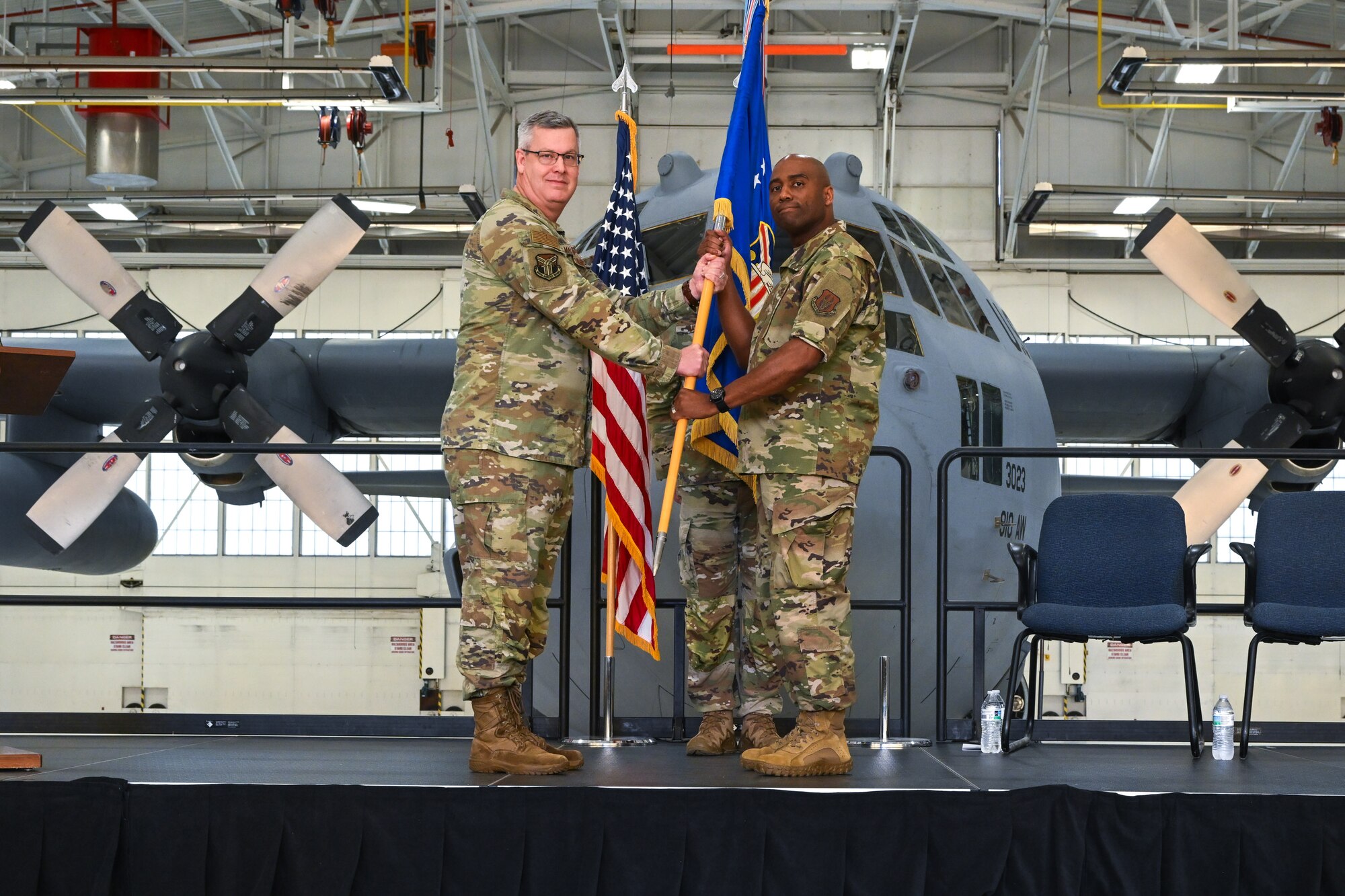 Chief Master Sgt. Howard Dixon, 910th Airlift Wing command chief, receives the AW guidon from Col. Michael Maloney, 910th AW commander, during a change of responsibility ceremony at Youngstown Air Reserve Station, Ohio, Oct. 5, 2024.