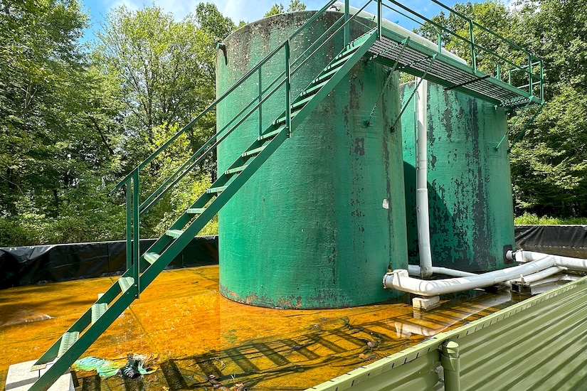 Two large above-ground wells stand in a shallow pool. Stairs lead to the tops of the towers.