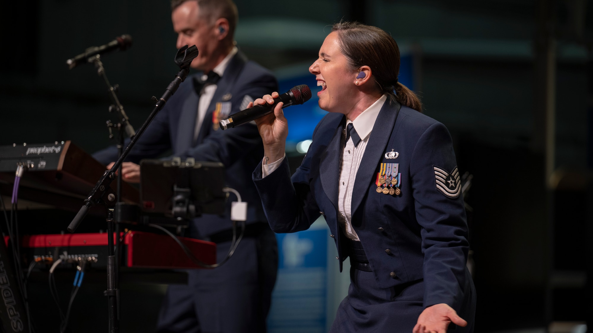 Ainsley DeWitt singing at a Flight One concert.