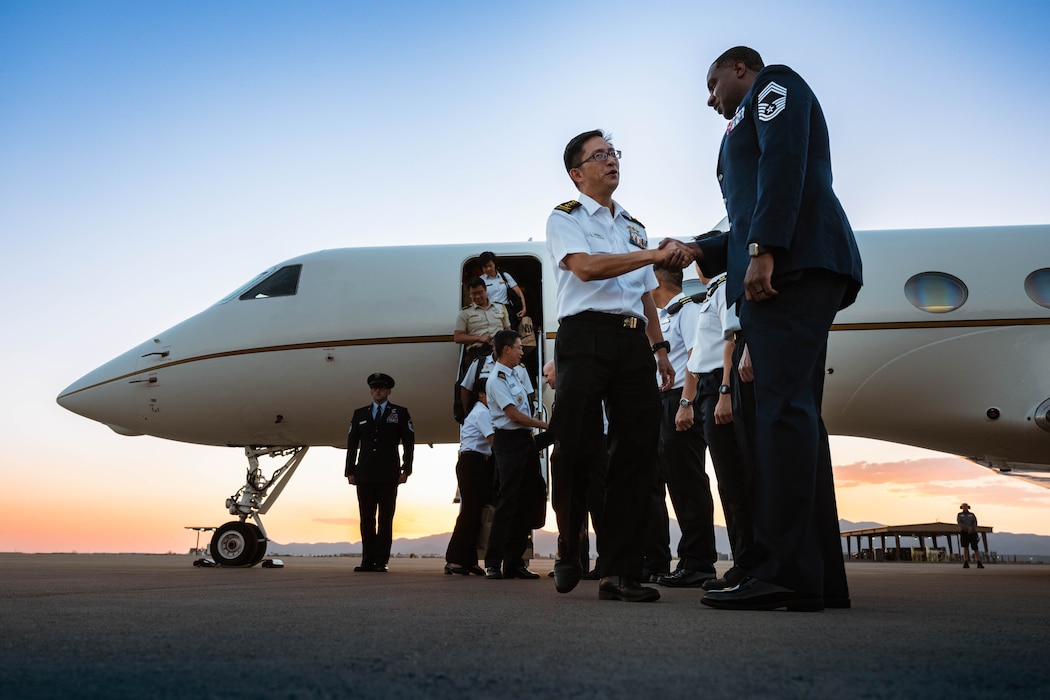 Singapore Armed Forces Vice Adm. Aaron Beng (left), Chief of Defense Force, shakes hands with U.S. Air Force Chief Master Sgt. Quentin Davis (right), 56th Medical Group senior enlisted leader.