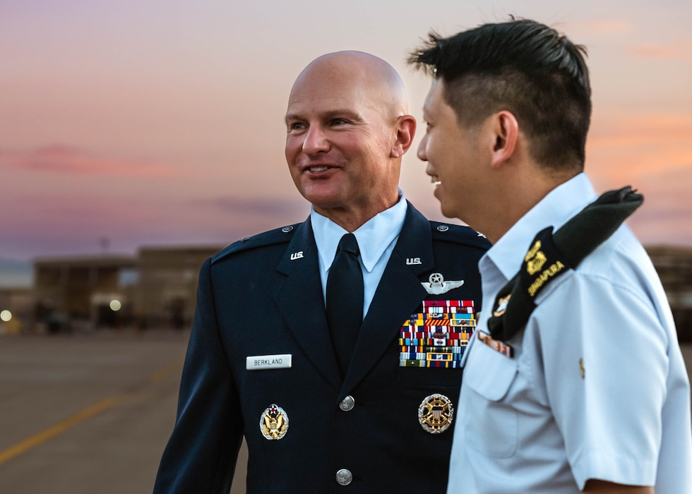 U.S. Air Force Brig. Gen. David Berkland, 56th Fighter Wing commander, speaks to Lt. Col. Yong Chin Tan, 425th Fighter Squadron commander, during the arrival of Singapore Armed Forces Vice Adm. Aaron Beng, Chief of Defense Force.