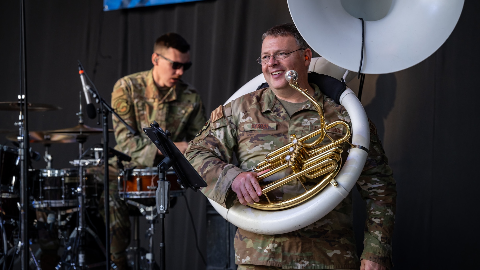 MSgt Adam Porter posing and smiling with his tuba.