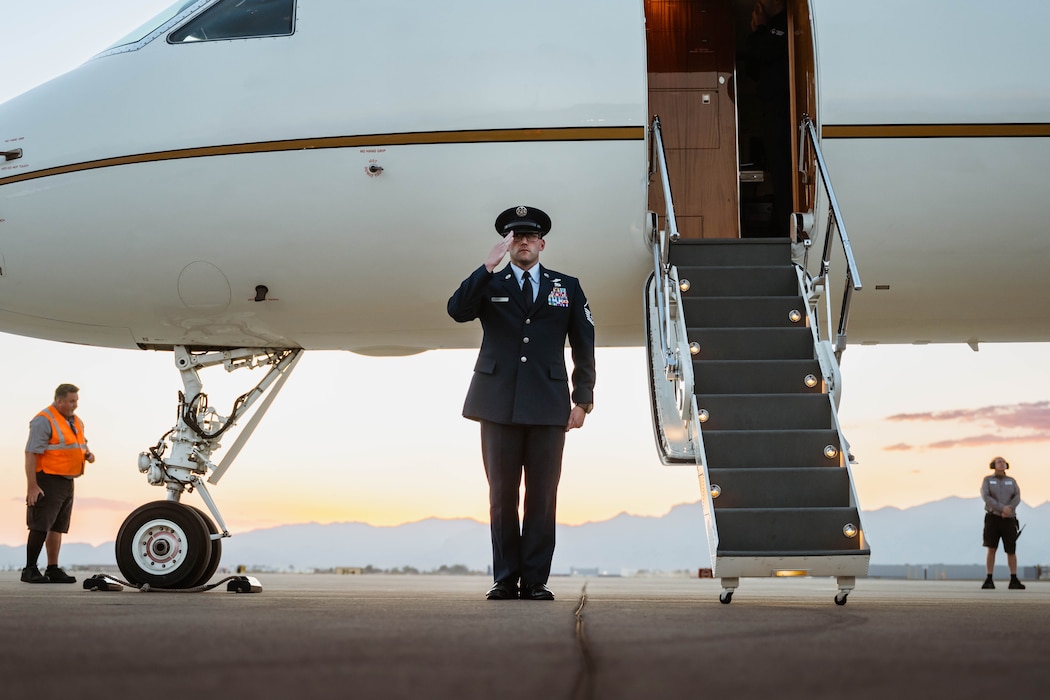 U.S. Air Force Master Sgt. William Chavez, 99th Airlift Squadron flight engineer, salutes as Singapore Armed Forces Vice Adm. Aaron Beng, Chief of Defense Force, and his party depart the flightline.