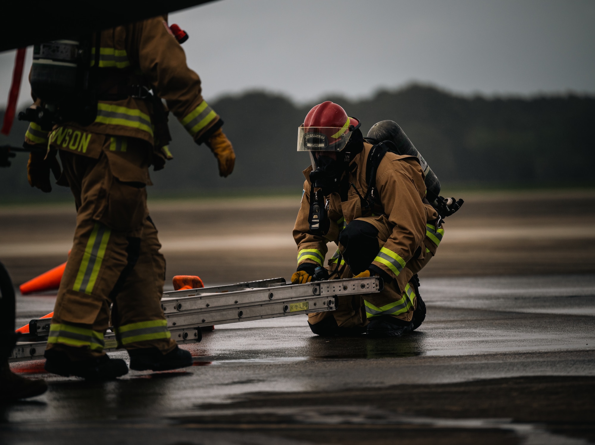 Fireman places a ladder on the ground