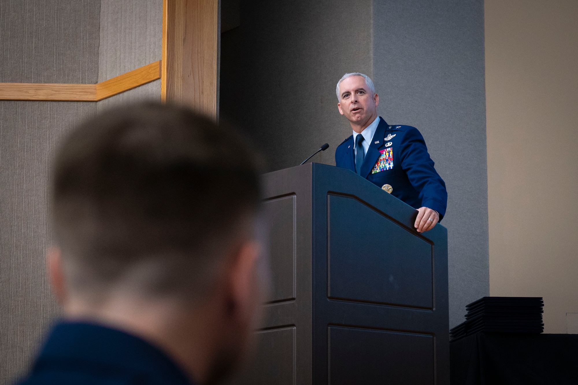U.S. Air Force Brig. Gen. Daniel Begin, Director of Air Mobility Command Legislative Affairs, National Capitol, speaks during Class 25-01’s Undergraduate Pilot Training (UPT) graduation at Laughlin Air Force Base, Texas, Oct. 11, 2024. Begin became the first T-1A Jayhawk First Assignment Instructor Pilot upon his graduation from UPT in 1998 at Laughlin AFB, and was invited back as a guest speaker for the event. (U.S. Air Force photo by Senior Airman Kailee Reynolds)