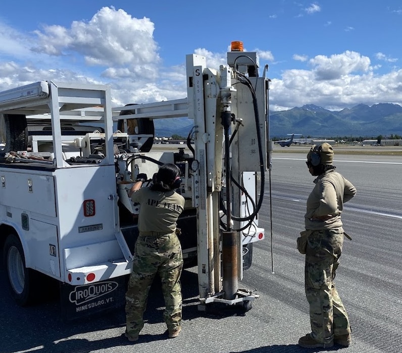 members of the AFCEC APE team get ready to extract a core from the runway