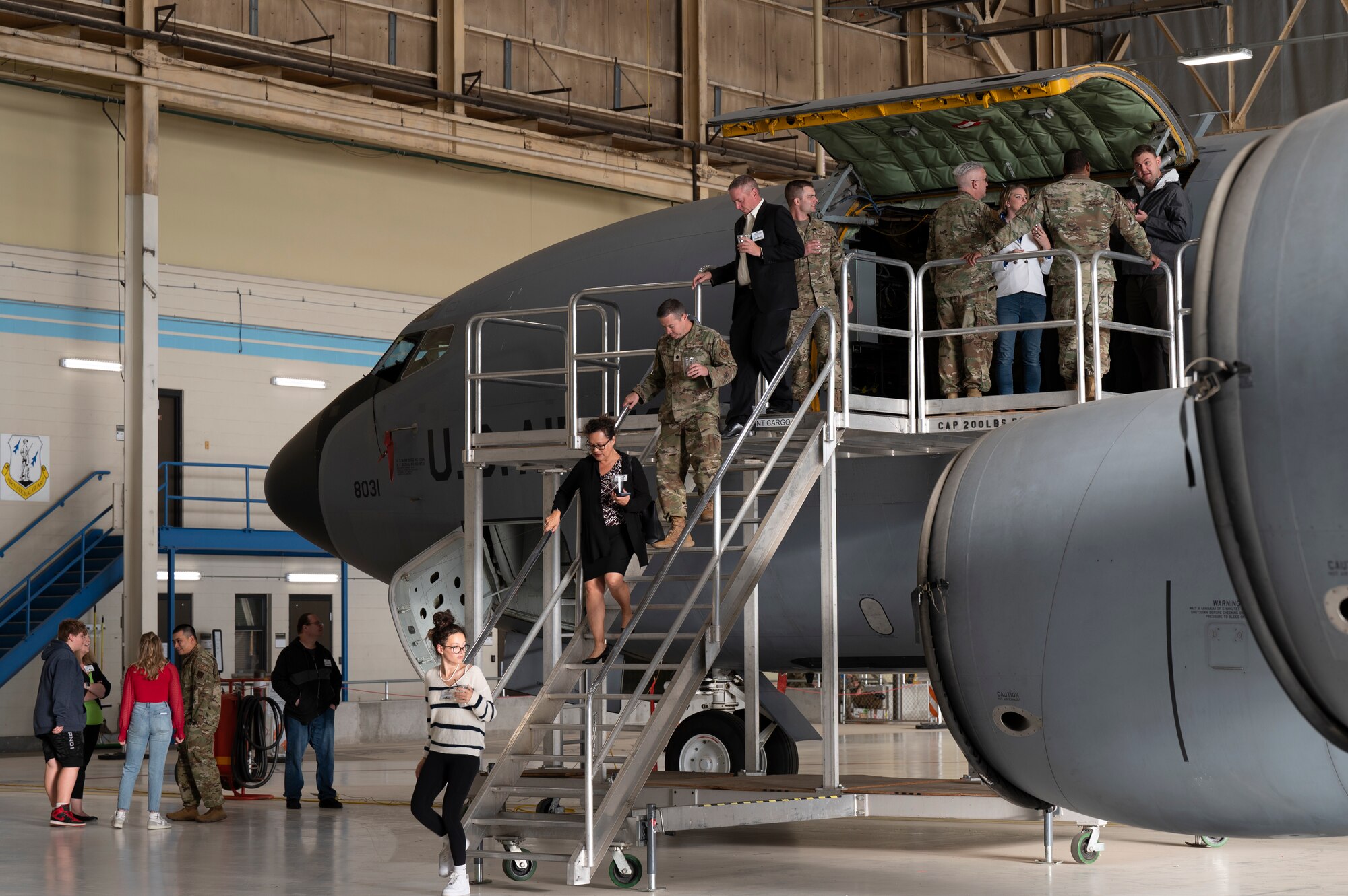 Individuals tour the inside of a KC-135 Stratotanker.