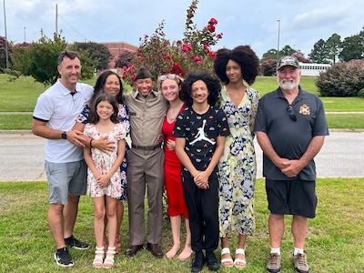 U.S. Army 1st Lt. Andrew Devine, far left, stands for a photograph with his son, then U.S. Army Pvt. Isaiah Castellanos, following Castellanos' completion of Basic Combat Training at Fort Jackson, S.C., on Aug. 10, 2023. 1st Lt. Devine served on active duty from 2004 to 2010, and joined the D.C. National Guard in 2020. His son joined in 2023.