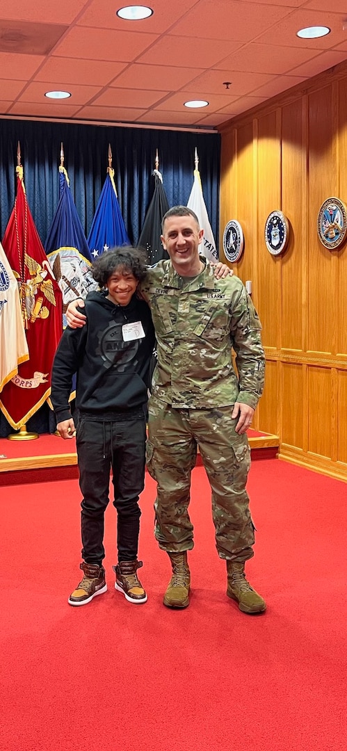 U.S. Army 1st Lt. Andrew Devine, right, stands for a photograph with his son, Isaiah Castellanos, following Castellanos' oath of enlistment at the Military Entrance Processing Station-Baltimore, at Fort Meade, Md., in January 2023. 1st Lt. Devine served on active duty from 2004 to 2010, and joined the D.C. National Guard in 2020. His son joined the organization three years later.