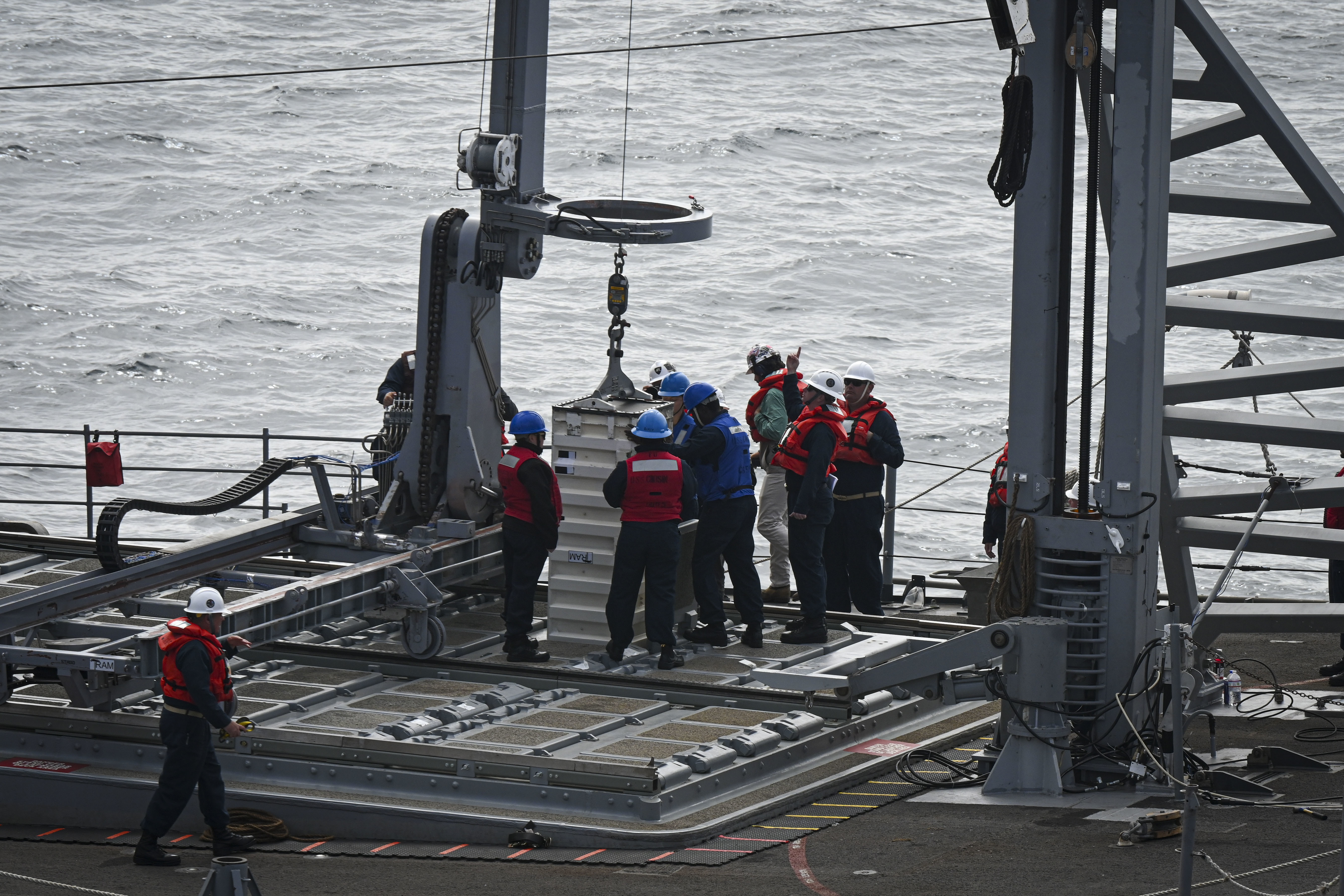 SECNAV Carlos Del Toro visits USNS Washington Chambers (T-AKE 11) during a demonstration of VLS reloading at-sea with USS Chosin (CG-65).