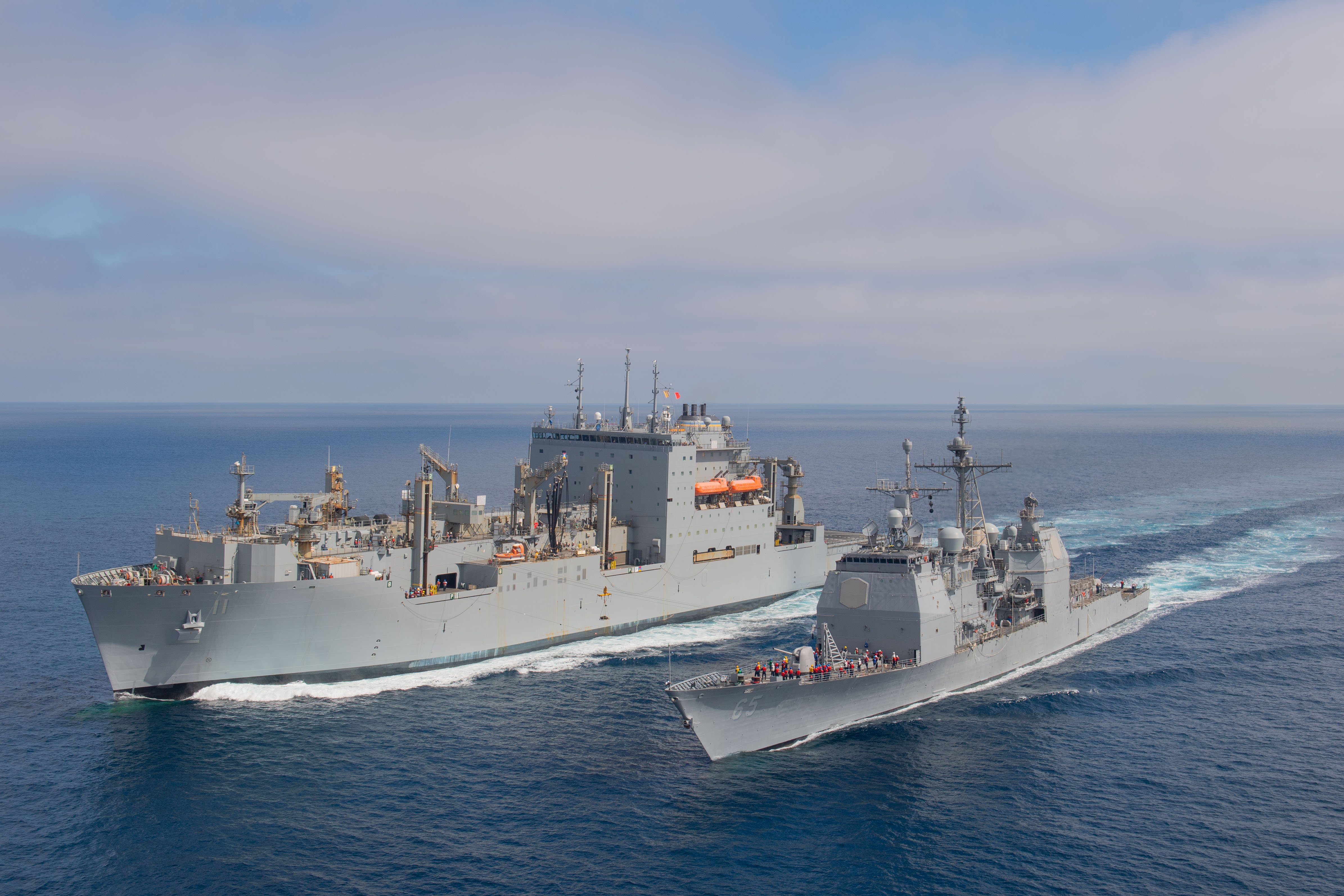 USS Chosin (CG 65) and USNS Washington Chambers (T-AKE 11) during an at-sea demonstration of the Transferrable Reload At-sea Method (TRAM) while underway in the Pacific Ocean.