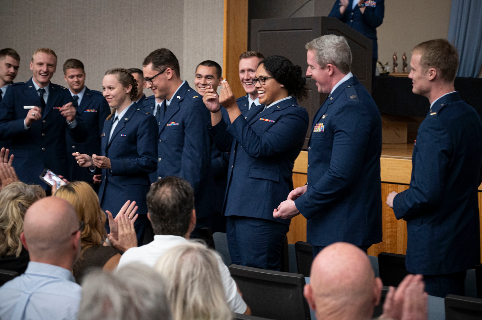 U.S. Air Force pilots from Class 25-01 break their wings during their Undergraduate Pilot Training (UPT) graduation ceremony at Laughlin Air Force Base, Texas, Oct. 11, 2024. Tradition holds that a pilot's first pair of wings should be broken in two, with one half kept by the pilot and the other given to a significant person, to ensure good fortune in the pilot's aviation career. (U.S. Air Force photo by Senior Airman Kailee Reynolds)