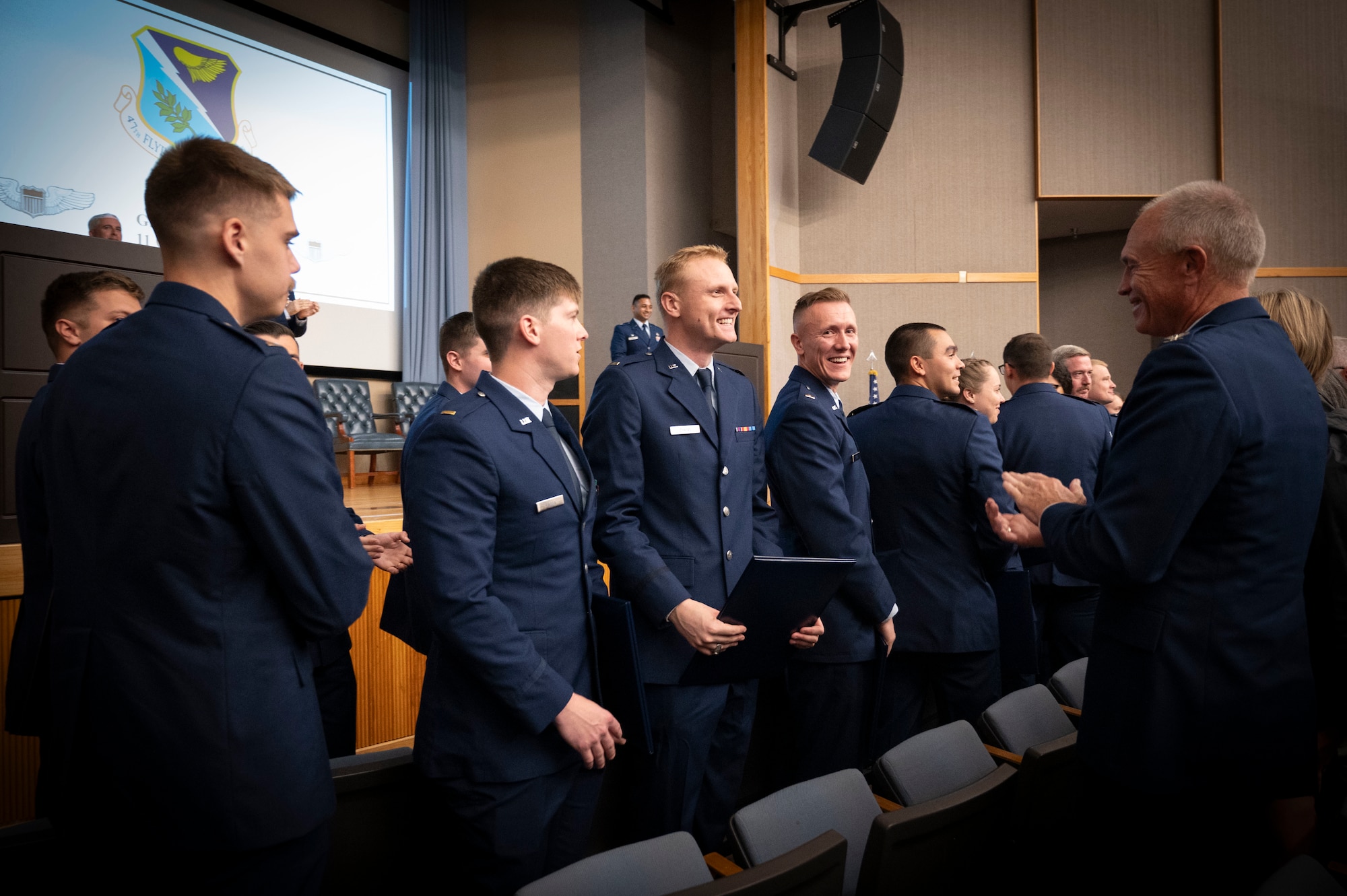 U.S. Air Force pilots from Class 25-01 smile after receiving their wings during their Undergraduate Pilot Training (UPT) graduation ceremony at Laughlin Air Force Base, Texas, Oct. 11, 2024. Tradition holds that a pilot's first pair of wings should be broken in two, with one half kept by the pilot and the other given to a significant person, to ensure good fortune in the pilot's aviation career. (U.S. Air Force photo by Senior Airman Kailee Reynolds)