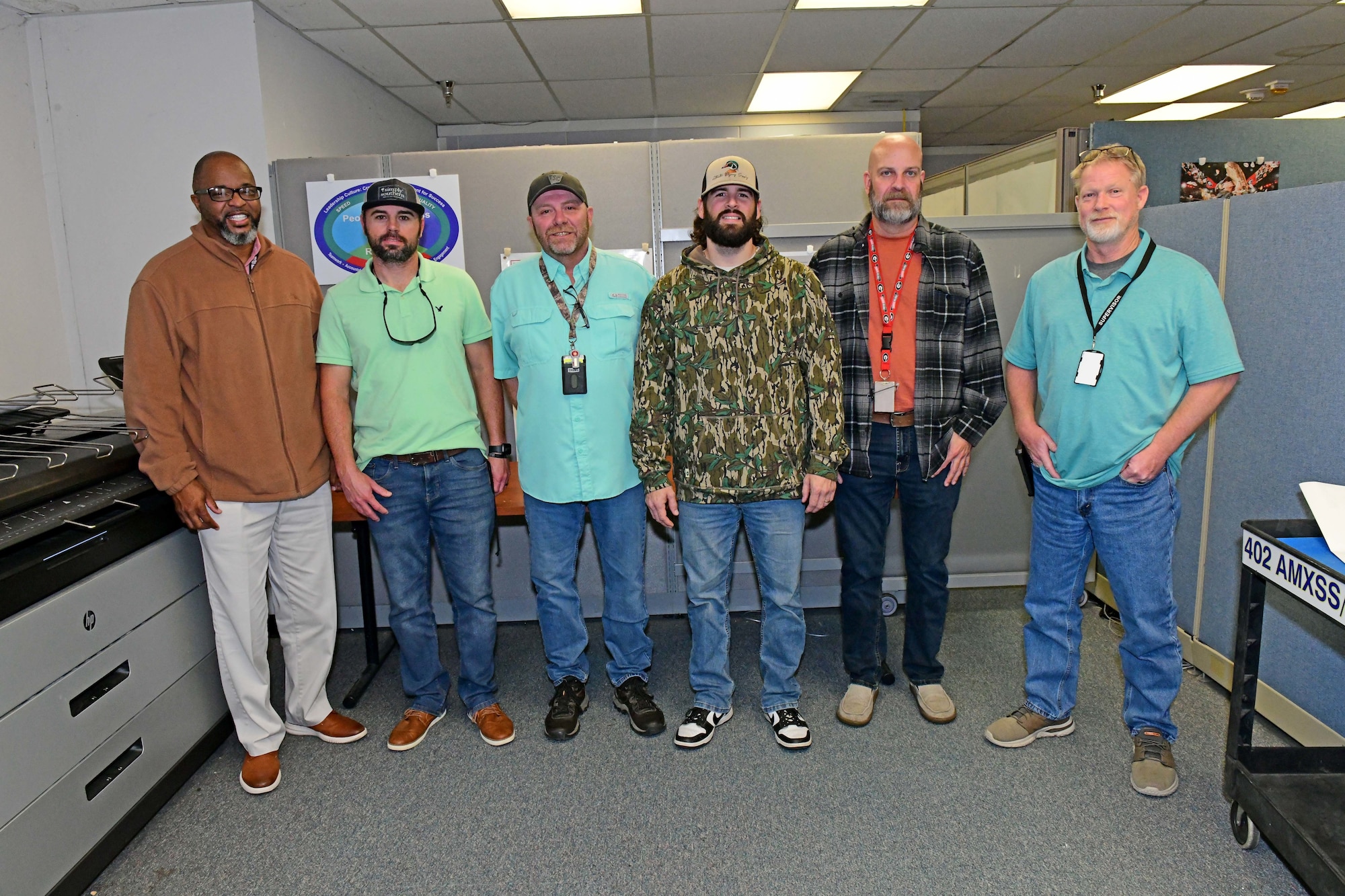 A group of people standing and posing at the camera