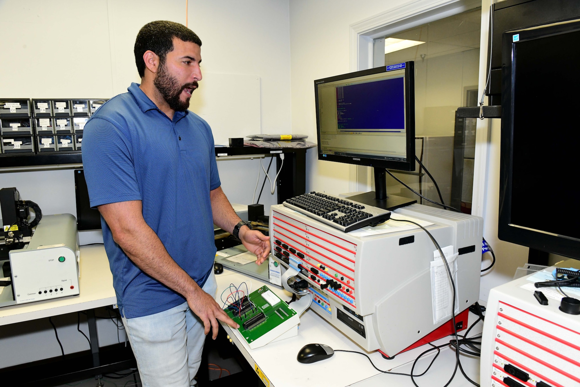 Man standing while testing a digital to analog converter