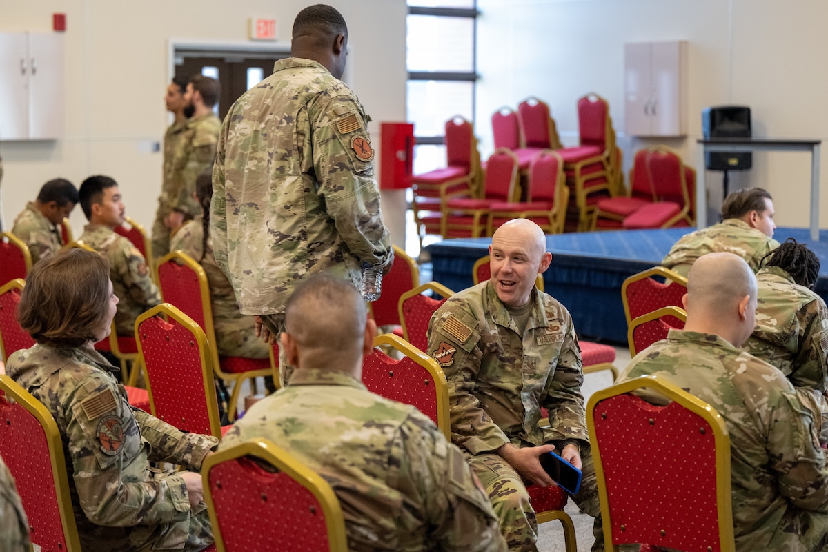 A photo of Airmen talking.