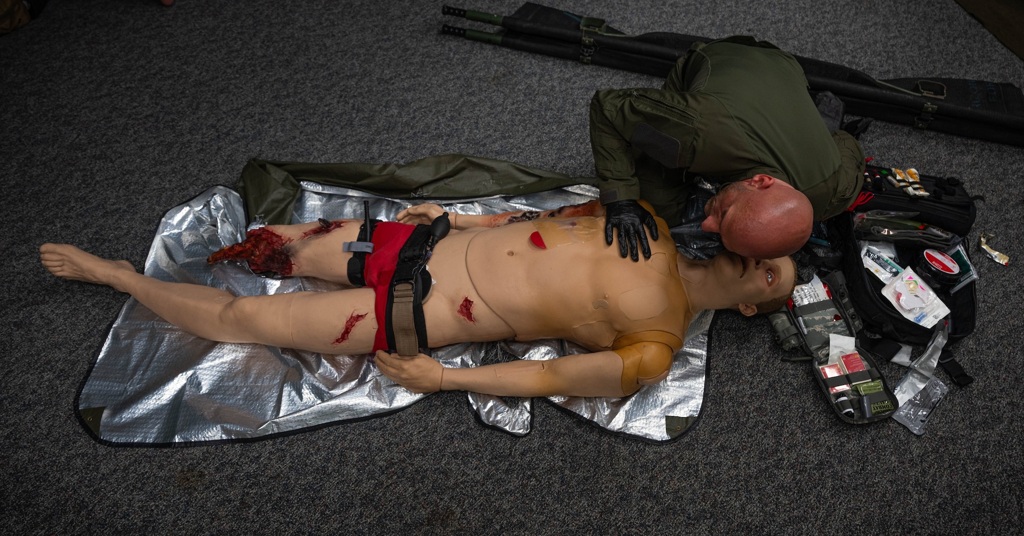 A German SWAT member performs an airway assessment on a simulated patient while receiving Tactical Combat Casualty Care training at Ramstein Air Base, Germany, Oct. 9, 2024. Throughout the week, 16 German SWAT members were trained how to treat massive bleeding by using equipment such as simulated patient mannequins. (U.S. Air Force Photo by Senior Airman Jared Lovett)
