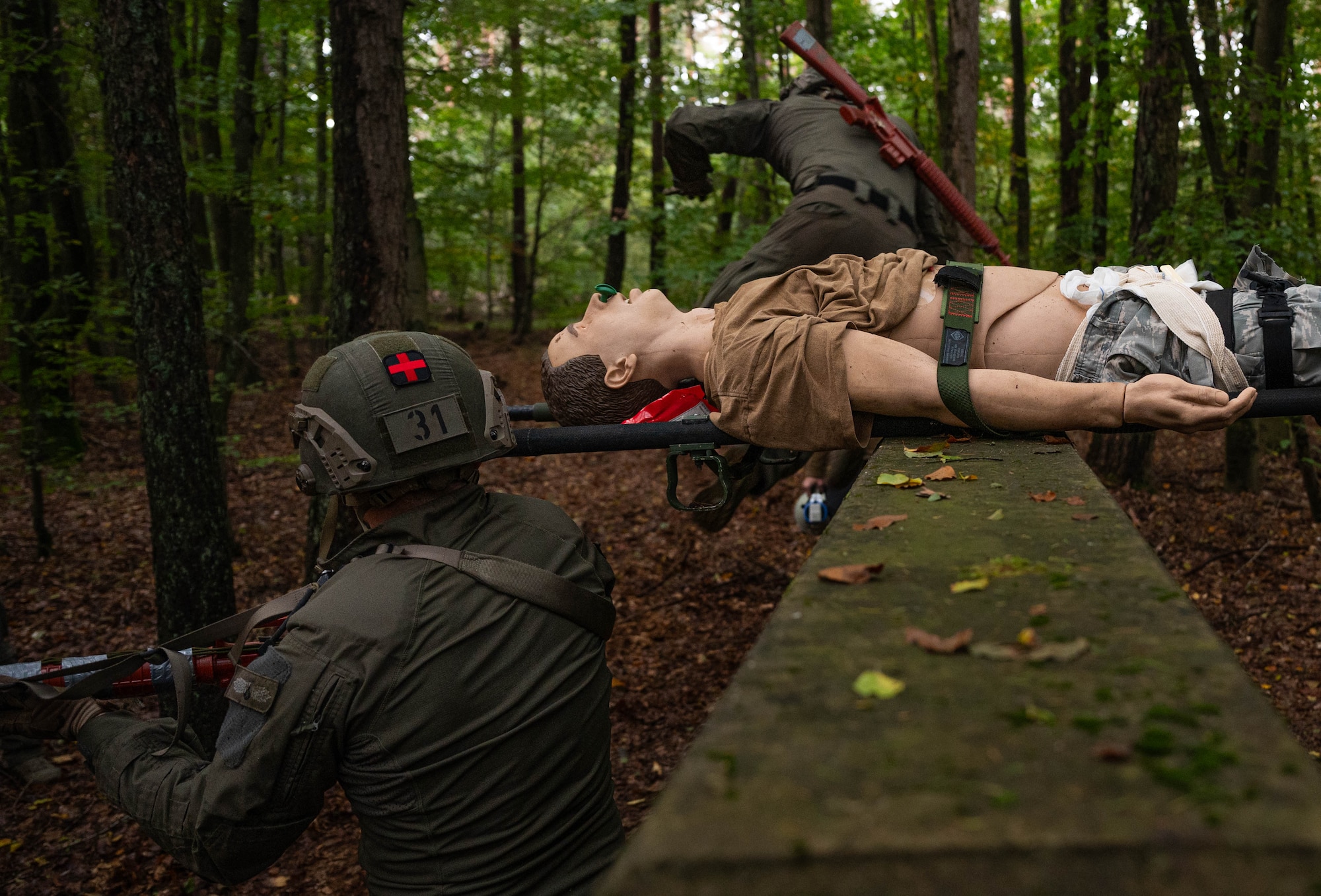 German SWAT members complete a casualty obstacle course while receiving Tactical Combat Casualty Care training at Landstuhl, Germany, Oct. 10, 2024. The 16 German SWAT members training on the course had to crawl and maneuver through obstacles and terrain while simultaneously evacuating and treating a simulated patient. (U.S. Air Force Photo by Senior Airman Jared Lovett)