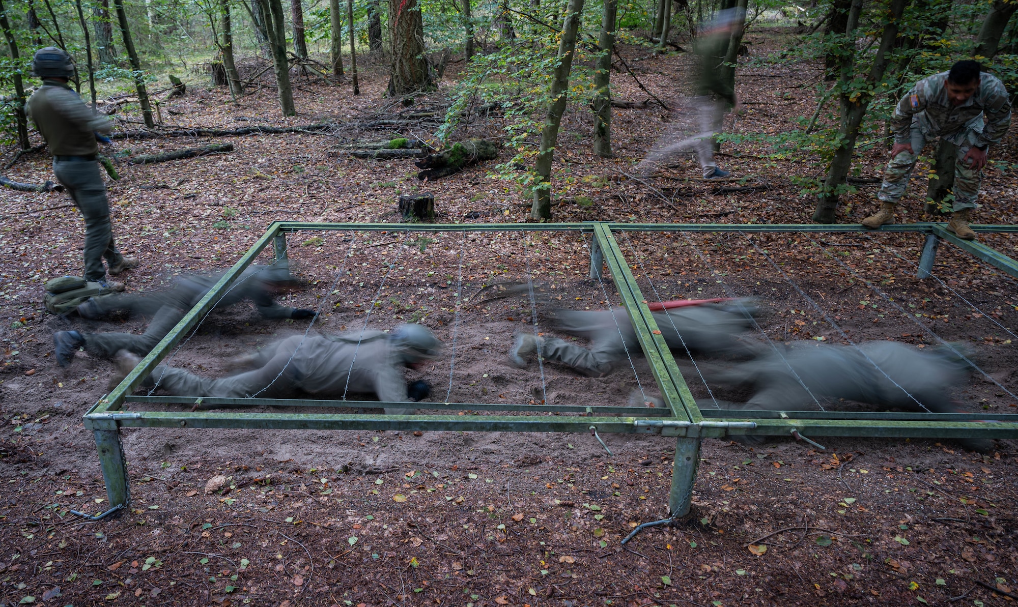 German SWAT members train in a casualty obstacle course while receiving Tactical Combat Casualty Care training at Landstuhl, Germany, Oct. 10, 2024. The 16 German SWAT members training on the course had to crawl and maneuver through obstacles and terrain while simultaneously evacuating and treating a simulated patient. (U.S. Air Force Photo by Senior Airman Jared Lovett)