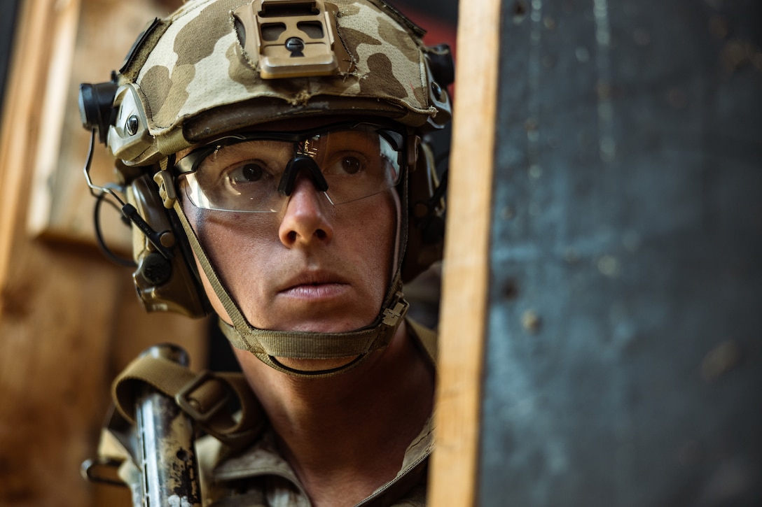 Close-up of a Marine wearing a helmet and eye protection during daylight.