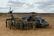 U.S. Army crew members assigned to Alpha Company, 2nd Battalion, 227th Aviation Regiment, 1st Air Cavalry Brigade, 1st Cavalry Division, explain the different sections of a UH-60 Black Hawk to soldiers from several NATO countries before taking them on a flight during Operation Iron Wolf at Camp Herkus, Lithuania, Oct.13, 2024. Operation Iron Wolf was a NATO Multinational Battlegroup exercise led by the Lithuanian army. The 1st Cavalry Division’s mission is to engage in multinational training and exercises across the continent, strengthening interoperability with NATO allies and regional security partners, which provides competent and ready forces to V Corps, America’s forward-deployed corps in Europe. (U.S. Army photo by Staff Sgt. Richard Wooten)