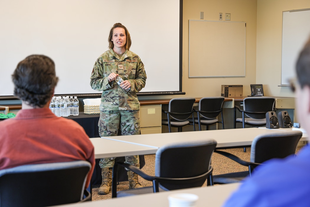 U.S. Air Force Tech. Sgt. Melissa Nitz Crabill, acting first sergeant for the 127th Air Refueling Group, Michigan Air National Guard, gives a mission briefing to visitors in Gwinn, Michigan, Oct.1, 2024. Nearly 100 Airmen from the 127th Air Refueling and 127th Mission Support Groups, temporarily dispersed to Marquette Sawyer Regional Airport in Gwinn and Detroit Metropolitan Wayne County Airport in Romulus while the runway was repaired at Selfridge Air National Guard Base. (U.S. Air National Guard photo by Tech. Sgt. Andrew Schumann)