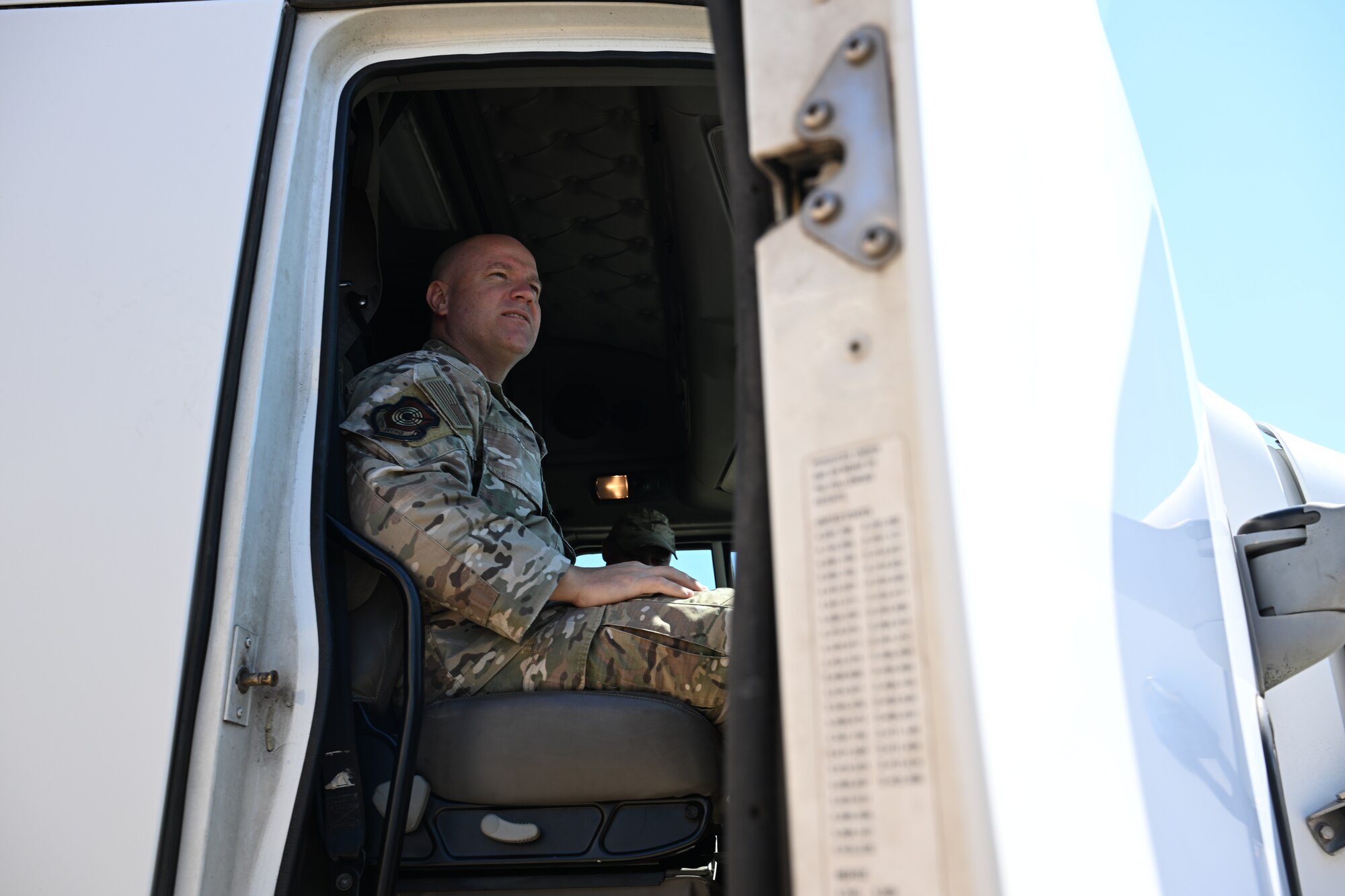 U.S. Air Force Chief Master Sgt. Jason K. Trickey, 57th Wing command chief, sits in the passenger seat of 16th Electronic Warfare Squadron’s tractor-trailer during a visit to Eglin Air Force Base, Florida, Oct. 7, 2024. Trickey immersed with several squadrons during his immersion with the 350th Spectrum Warfare Wing, learning about their unique mission sets. (U.S. Air Force photo by Senior Airman Anna Smith)