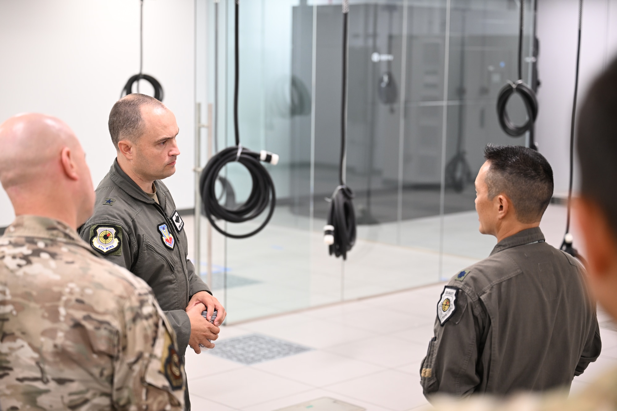U.S. Air Force Lt. Col. Chad Nishizuka, 16th Electronic Warfare Squadron commander, right, briefs U.S. Air Force Brig. Gen. Lawrence T. Sullivan, 57th Wing commander, second from left, about the units mission to support U.S. Air Force Global Strike assets at Eglin Air Force base, Florida, Oct. 7, 2024. Sullivan visited multiple units while in the Florida panhandle, learning how each wing’s missions go hand-in-hand with Nellis Air Force Base’s mission. (U.S. Air Force photo by Senior Airman Anna Smith)