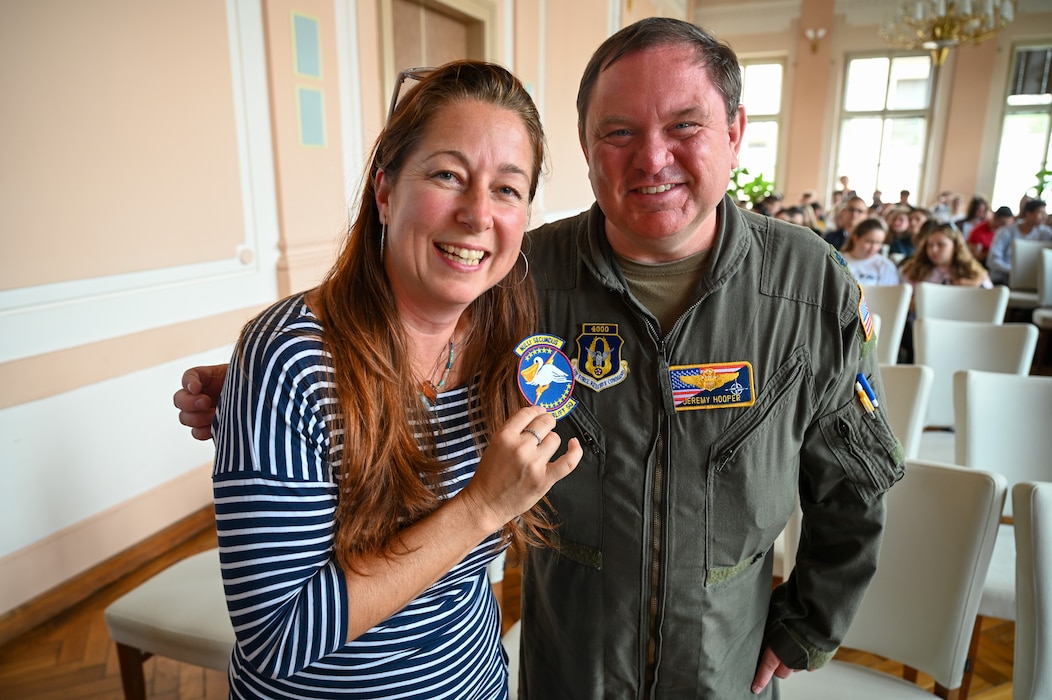 Lt. Col. Jeremy Hooper, 68th Airlift Squadron C-5 pilot evaluator, gifts a 68th AS unit patch to Marie Stuchla, magister of language, at Masarykovo gymnázium Příbor, a high School in the Czech Republic, Sept. 24, 2024.