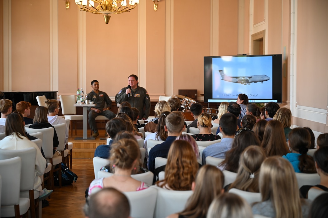 Lt. Col. Jeremy Hooper, left, 68th Airlift SquadronC-5 pilot evaluator, introduces himself to students from Masarykovo gymnázium Příbor, a high School in the Czech Republic, during a seminar about serving in the United States Air Force, Sept. 24, 2024.