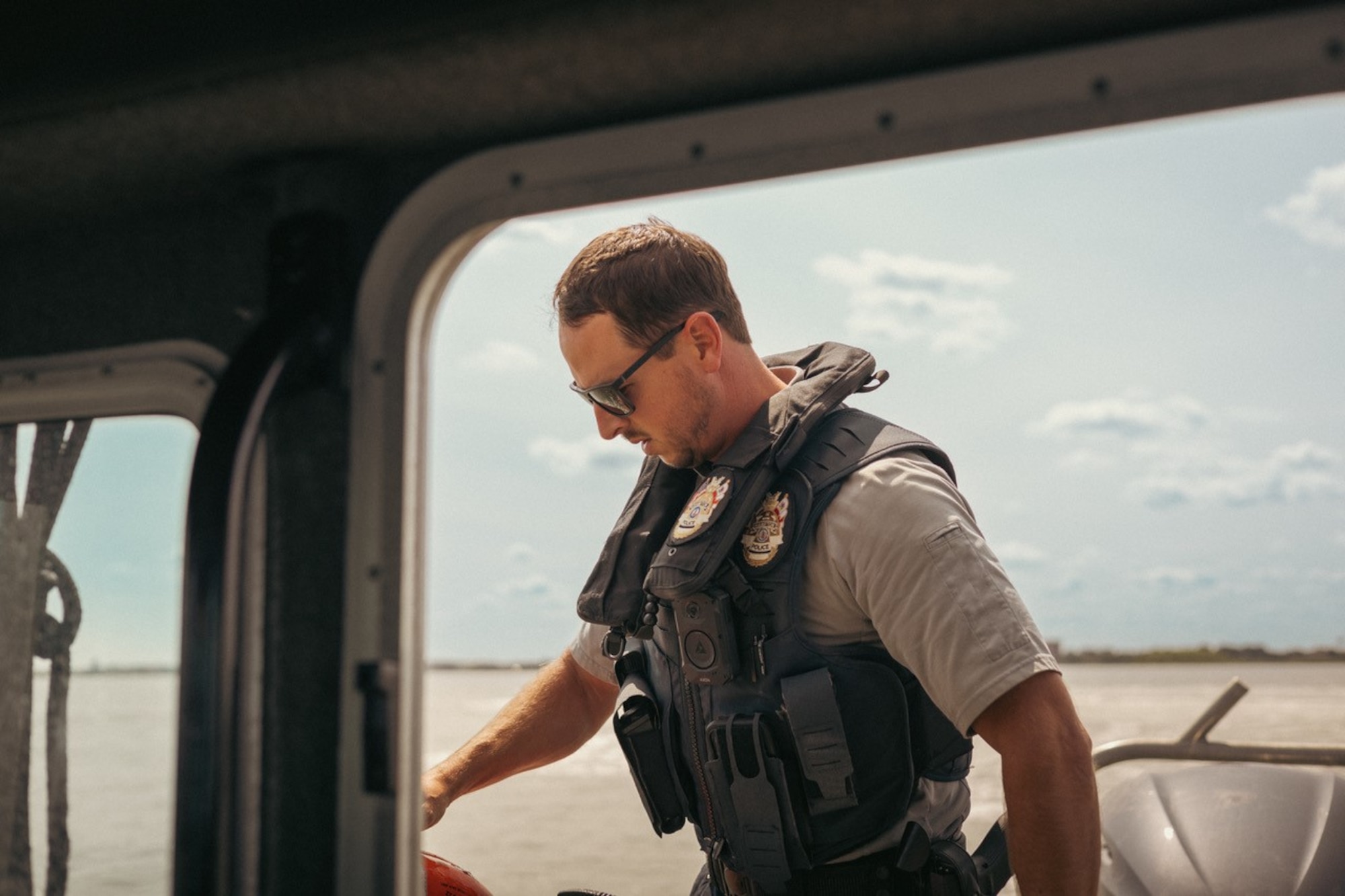 A man stands on a boat at sea.