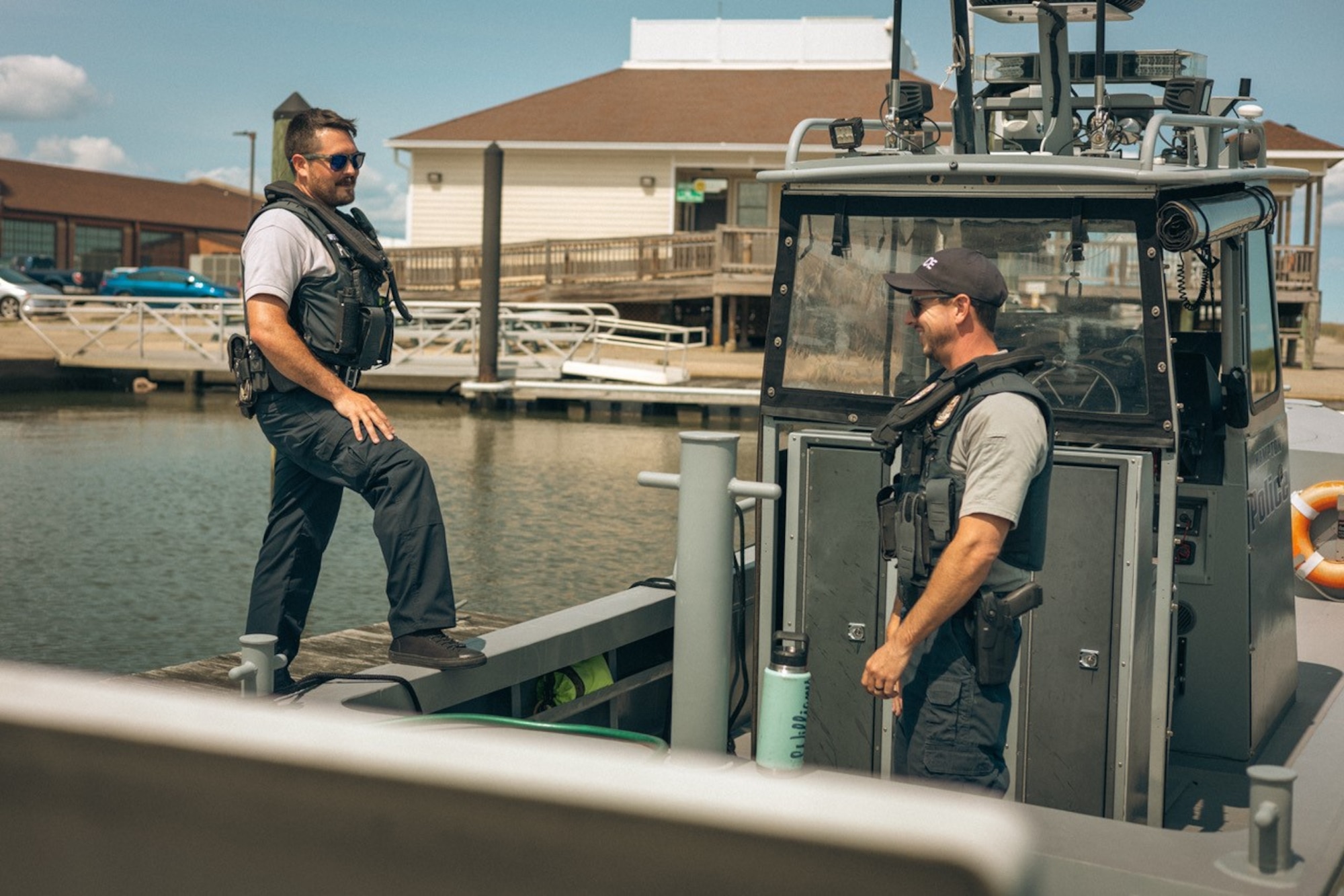 Two men stand on a boat.