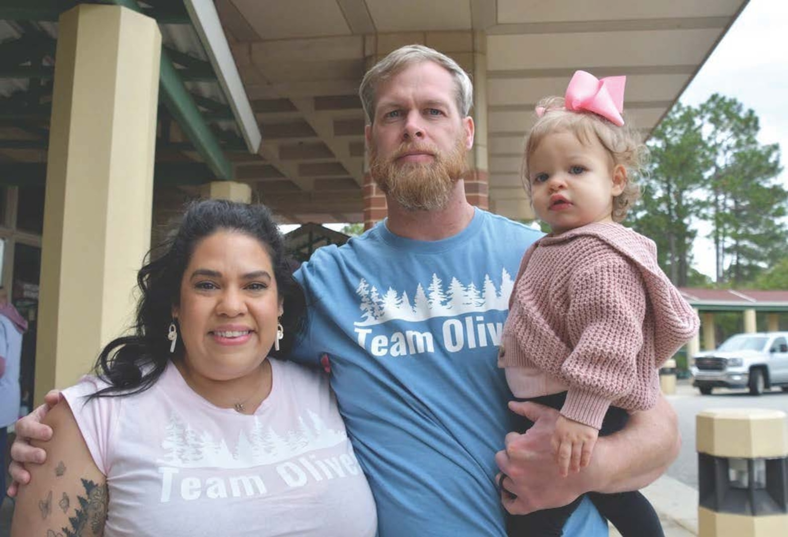 Photo By Dan Grubb | Hartman, left, joins husband Jason and daughter Olivia in remembering the Hartman’s son, Oliver. The Walk to Remember has been a Womack tradition for almost two decades.