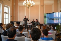 Staff Sgt. Jaylen Myles, 68th Airlift Squadron C-5 flight engineer instructor, introduces himself to students from Masarykovo gymnázium Příbor, a high School in the Czech Republic, during a seminar about serving in the United States Air Force, Sept. 24, 2024.
