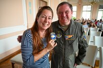 Lt. Col. Jeremy Hooper, 68th Airlift Squadron C-5 pilot evaluator, gifts a 68th AS unit patch to Marie Stuchla, magister of language, at Masarykovo gymnázium Příbor, a high School in the Czech Republic, Sept. 24, 2024.