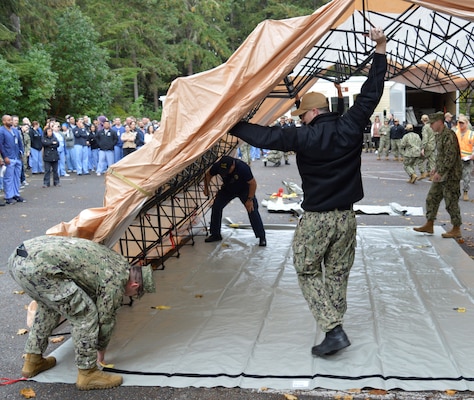 Tremor Tent for Triage…Even though there were no reported injuries in NHB mock earthquake drill October 15, 2024 - held in conjunction with Commander Naval Installations Command Citadel Rumble and Operation Dynamo 2024 - which featured mass evacuation from the military treatment facility and full accountability of staff, patient and visitor, Urgent Care Clinic staff proactively brought medical treatment gear and a casualty tent was positioned to handle any potential incoming casualties. (Official Navy photo by Douglas H Stutz, NHB/NMRTC Bremerton public affairs officer)