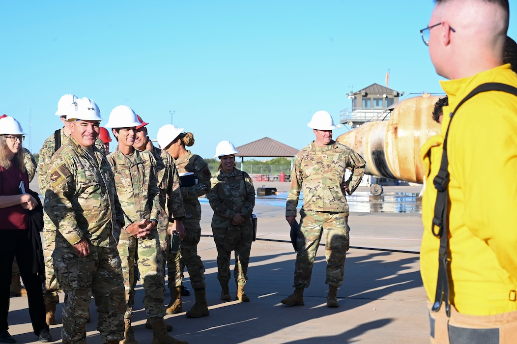 U.S. Air Force Maj. Gen. Wolfe Davidson, Second Air Force Commander, and Chief Master Sgt. Kristina Montgomery, Second Air Force Command Chief, discusses with students their experience at the 312th Training Squadron, Louis F. Garland Department of Defense Fire Academy, Goodfellow Air Force Base, Texas, Oct. 1, 2024. The 312th TRS mission is to train, develop, and inspire warriors to deliver fire emergency services and nuclear treaty monitoring for the Department of Defense and our international partners. (U.S. Air Force photo by Airman 1st Class Madi Collier)